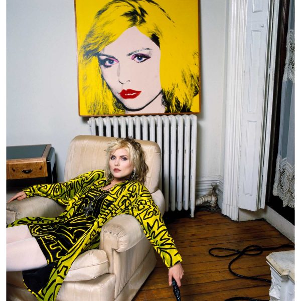 Debbie Harry photographed in her New York apartment with in front of her portrait by Andy Warhol. Limited edition artwork by Brian Aris.