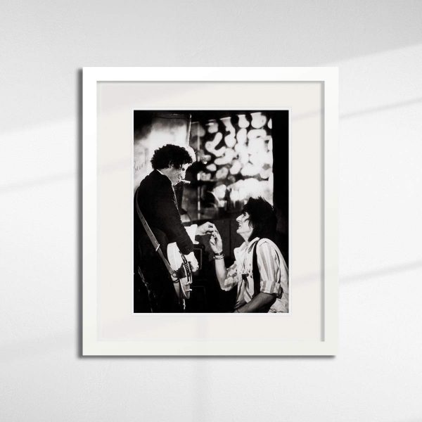 Keith Richards & Ronnie Wood, Paris, 1983 sharing a cigarette - by Brian Aris.